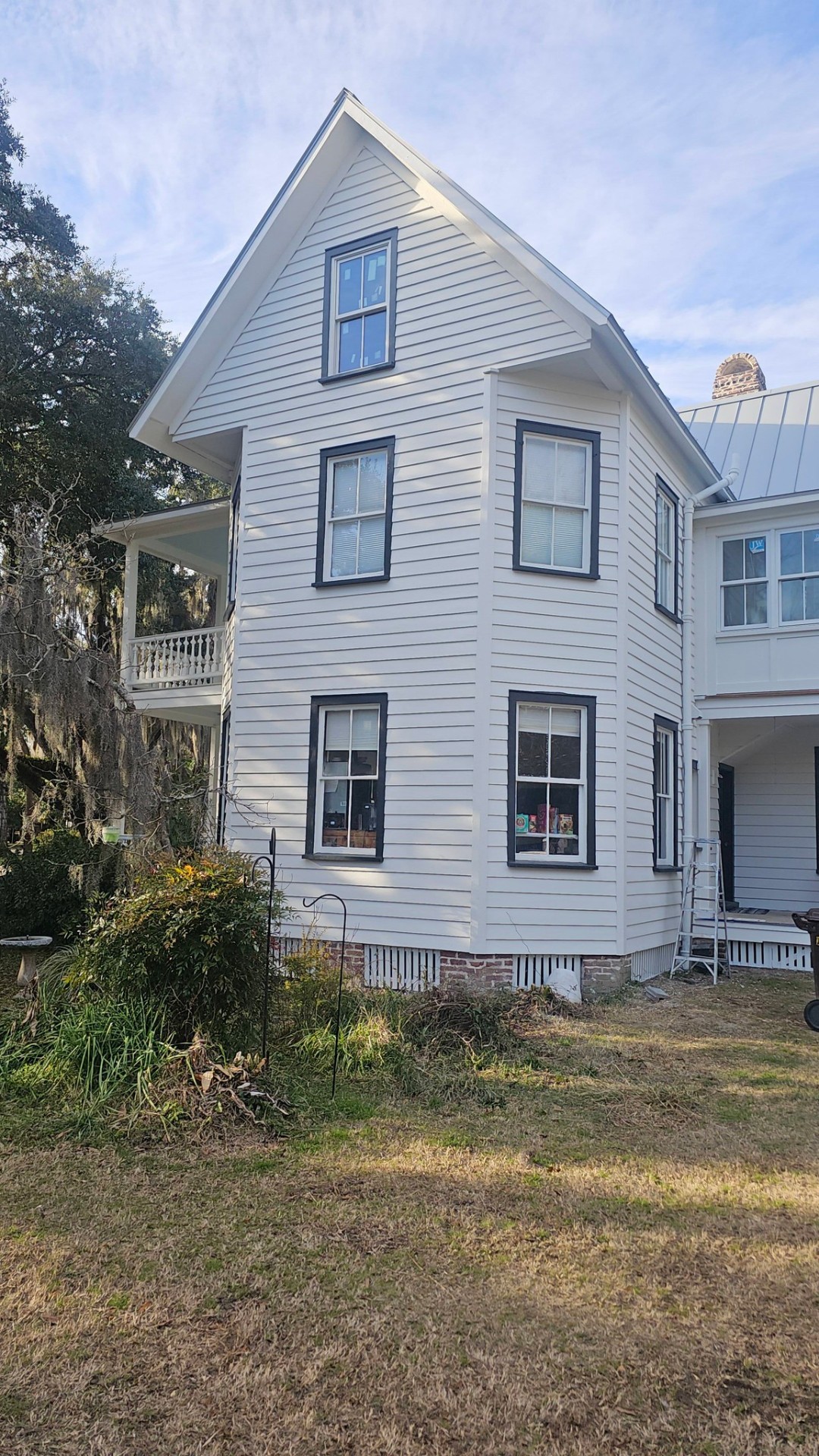 Restored historic exterior with crisp white siding and black trim